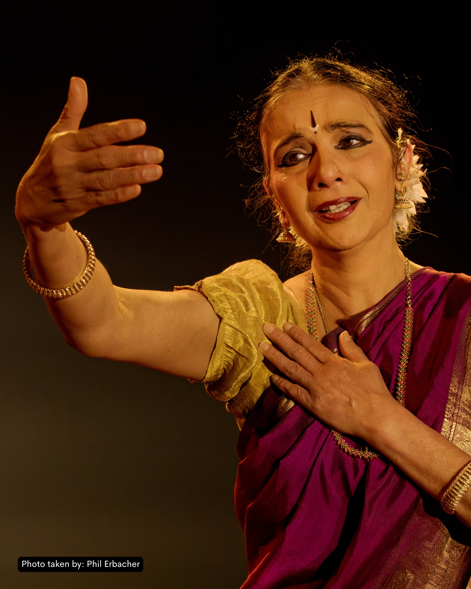 Hero production photo from And What Will People Say? — Kersh in mid-Bharatanatyam pose under deep amber stage light.